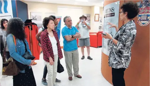  ??  ?? Dr Suzanne Francis-Brown, curator (right) at The University of the West Indies (UWI) Museum, briefs visitors who travelled to Jamaica to tour the former WWII refugee campsite, located on the UWI Mona campus.