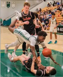  ?? ?? Palo Alto's Jorell Clark (12) collides with a Los Gatos player on his drive to the hoop.