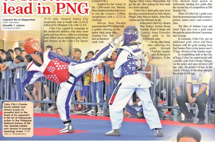  ?? PAUL JUN E. ROSAROSO ?? Cebu City’s Charles David Labiste (red armor) scores on powerful kick to the head of his opponent in this bit of taekwondo action in the Philippine National Games at SM City Seaside.Labiste won bronze in kyorugi (sparring) event.