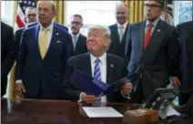  ?? EVAN VUCCI — THE ASSOCIATED PRESS ?? President Donald Trump, flanked by Commerce Secretary Wilbur Ross, left, and Energy Secretary Rick Perry, is seen in the Oval Office of the White House in Washington Friday during the announcing of the approval of a permit to build the Keystone XL...