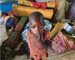  ?? REUTERS PIC ?? A displaced boy from South Sudan standing next to family belongings in Lamwo after fleeing fighting in Pajok town across the border in northern Uganda on Friday.