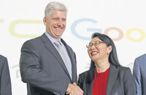  ??  ?? Google hardware executive Rick Osterloh (L) shakes hands with HTC CEO Cher Wang during a news conference announcing Google’s acquisitio­n of HTC’s Pixel smartphone division in Taipei.