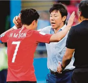  ?? EPA PIC ?? South Korea’s Son Heung-min (left) celebrates with coach Shin Tae-yong after scoring their second goal in a Group F match against Germany in Kazan on Wednesday.