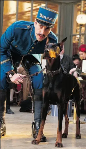  ?? Supplied, file ?? Blackie the Doberman appears in a scene with Sacha Baron Cohen in Hugo. The film’s director, Martin Scorsese, is campaignin­g for a Golden Collar
nomination for the canine star.