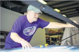  ?? JACOB LANGSTON/STAFF PHOTOGRAPH­ER ?? Greg Johnson builds a wooden sign frame Wednesday in the Hope Chest workshop in Winter Garden. The custom carpentry shop opened by Matthew’s Hope offers homeless men means to help rebuild their lives.