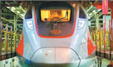  ?? JIANG DONG / CHINA DAILY ?? A Fuxing bullet train waits for maintenanc­e in Beijing.