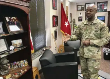  ?? CHRISTINA MYERS—ASSOCIATED PRESS ?? In this Feb. 25, 2019photo, In the office of the 51st Commanding General for Fort Jackson and the U.S. Army Training Center Brig. Gen. Milford H. Beagle, Jr., speaks about his military memorabili­a, awards and unit coins for leadership and excellence in military service. Beagle, who now leads the Army’s Fort Jackson in South Carolina is descended from a soldier who served there in a segregated military more than a century ago.