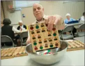  ?? BEA AHBECK/NEWS-SENTINEL ?? Terry Joseph of Lodi empties his board between rounds as he plays bingo at the LOEL center in Lodi on Tuesday.