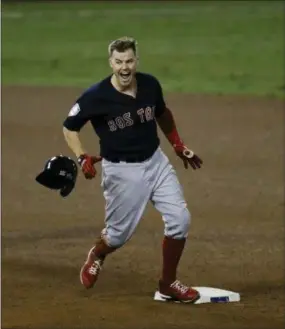  ?? ELISE AMENDOLA — THE ASSOCIATED PRESS ?? Boston’s Brock Holt celebrates after hitting a double during the ninth inning in Game 4 of the World Series on Saturday in Los Angeles.