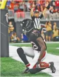  ?? AP PHOTO/JOHN AMIS ?? Atlanta Falcons wide receiver Calvin Ridley kneels down after making an 11-yard touchdown catch in the second quarter of Sunday’s loss to the Cincinnati Bengals. Ridley had a 30-yard touchdown catch in the fourth quarter.