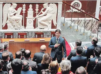  ?? FRANCOIS MORI THE ASSOCIATED PRESS ?? Prime Minister Justin Trudeau acknowledg­es applause from lawmkers as he arrives at the French National Assembly in Paris on Tuesday, part of his two-day official visit to France.