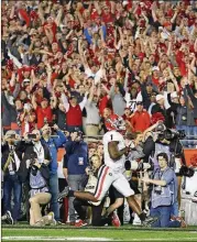  ??  ?? Michel scores the winning touchdown in overtime at the College Football Playoff Semifinal.