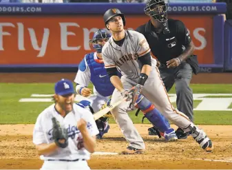  ?? Mark J. Terrill / Associated Press ?? The Giants’ Buster Posey follows the flight of his third-inning homer off a somewhat perturbed Clayton Kershaw. It was Posey’s first extra-base hit since he was beaned April 10.