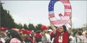  ?? (File Photo/AP/Matt Rourke) ?? A protester holding a Q sign waits in line in August 2018 with others to enter a campaign rally with President Donald Trump in Wilkes-Barre, Pa. Facebook and Twitter promised to stop encouragin­g the growth of the baseless conspiracy theory QAnon, which fashions Trump as a secret warrior against a supposed child-traffickin­g ring run by celebritie­s and government officials.