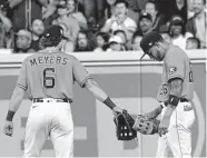  ?? Karen Warren/Staff photograph­er ?? The Astros’ Jose Siri is checked on by Jake Meyers after going after a foul ball hit into the stands Friday.