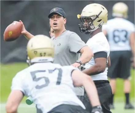  ?? Cliff Grassmick, Daily Camera ?? First-year University of Colorado defensive coordinato­r D.J. Eliot, above, has been employed by nine schools since 1999 but has some Rocky Mountain roots because he played linebacker for Wyoming during his college days.