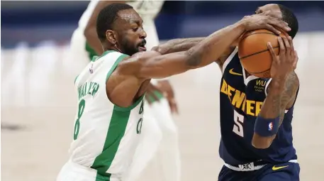  ?? Ap pHotos ?? ‘BIG ENERGY PLAY’: Kemba Walker knocks the ball out of Will Barton’s hand during the Celtics’ big second-half run against Denver.