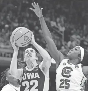  ?? ZACH BOYDEN-HOLMES/DES MOINES REGISTER ?? Iowa guard Caitlin Clark shoots against South Carolina guard Raven Johnson on Sunday in Cleveland.