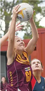  ?? ?? Left: Drouin’s Stacie Gardiner leaps for the ball against Bairnsdale’s Paris Dunkley in A grade on Saturday.