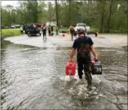  ?? ALLEN G. BREED — THE ASSOCIATED PRESS ?? Kevin Knox carries gas and a generator after being rescued from his flooded neighborho­od from the effects of Florence, now a tropical storm, in New Bern, N.C., on Saturday.