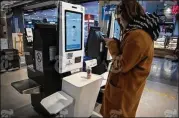  ?? GIULIA MARCHI / NYT ?? A woman pays with her phone at Hema, a Chinese grocery chain operated by internet giant Alibaba, in Beijing, March 15. Hema shoppers scan goods at checkout kiosks that use facial recognitio­n technology.