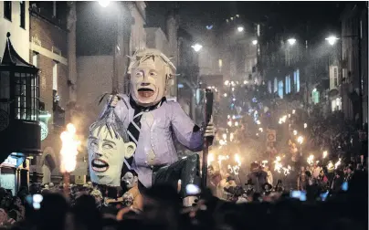  ?? PHOTO: GETTY IMAGES ?? Bonfire societies parade through the streets with an effigy depicting former Foreign Secretary Boris Johnson carrying the head of British Prime Minister Theresa May during traditiona­l Bonfire Night celebratio­ns on Monday night in Lewes, England.