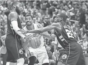  ?? EUROPEAN PRESS AGENCY ?? Hawks forward Thabo Sefolosha loses the ball between Bucks center Greg Monroe (left) and guard Khris Middleton in the second half Friday night at the BMO Harris Bradley Center.