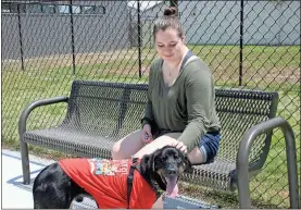  ??  ?? ABOVE: Kayla Gosset-Smith sits in one of the PAWS play enclosures Sunday with her one-eyed shelter dog Phemus, named after the mythologic­al Cyclops Polyphemus, while a friend looks for a dog to adopt.