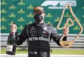  ??  ?? Mercedes driver Valtteri Bottas of Finland poses with the trophy after winning the Austrian Grand Prix yesterday. — Reuters