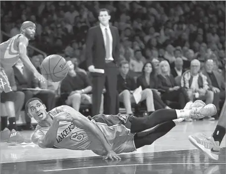  ?? Robert Gauthier Los Angeles Times ?? LAKERS GUARD Jordan Clarkson dives to save a loose ball in the first half against the Rockets. Clarkson got his third NBA season off to a rousing start, scoring 25 points to help make Luke Walton, shown standing, a winner in his Lakers coaching debut.