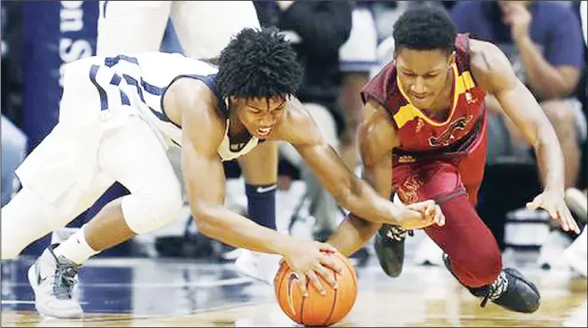  ??  ?? Butler’s Khalif Battle (left), and Louisiana Monroe’s Josh Nicholas (right), battle for a loose ball during the first half of an NCAA college basketball game, on Dec 28 in Indianapol­is. (AP)