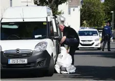  ?? Photo: Frank McGrath ?? A Garda forensics officer at the Fold Ireland complex, where two elderly men were assaulted.