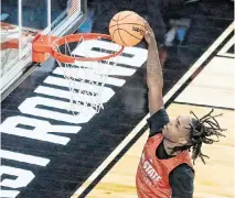  ?? KAITLIN MCKEOWN kmckeown@newsobserv­er.com ?? N.C. State’s Kam Woods dunks the ball during a practice on March 20, 2024, at PPG Paints Arena in Pittsburgh.