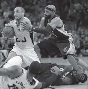  ?? The Associated Press ?? SPUR OF THE MOMENT: San Antonio guard Manu Ginobili (20) grabs a loose ball in front of Memphis counterpar­t Vince Carter in the first half of the Spurs’ Game 5 victory Tuesday night in their NBA Western Conference playoff series.