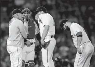  ?? MICHAEL DWYER/ AP PHOTO ?? Boston Red Sox pitching coach Dana LeVangie, left, talks with Nathan Eovaldi, center, during the fourth inning of a Tuesday’s game against the Cleveland Indians in Boston.