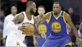  ?? TONY DEJAK — THE ASSOCIATED PRESS FILE ?? In this file photo, Cleveland Cavaliers forward LeBron James (23) drives on Golden State Warriors forward Kevin Durant (35) during the second half of Game 4of basketball’s NBA Finals in Cleveland. The NBA is driven by star power and its Christmas Day...