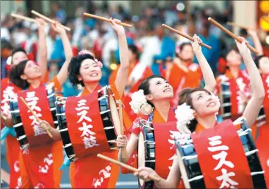  ?? KYODO NEWS VIA GETTY IMAGES ?? Taiko drummers march through a street in Morioka, Japan, on Tuesday, on the opening day of the four-day Morioka Sansa Odori Festival. This year marks the 40th anniversar­y of the festival.