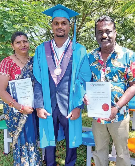  ?? Photo: Salote Qalubau ?? University of Fiji graduate and gold medalist Mohil Manish Pratap is flanked by his parents Mahend Pratap and Saras Wati on December 16, 2022 at the Saweni, Lautoka campus after the graduation ceremony.