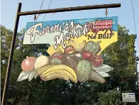  ?? Staff photo by Neil Abeles ?? ■ Atlanta’s Farmers’ Market sign, created by James Coleman and funded by Jerry Richardson, is a colorful addition to the Saturday market grounds.