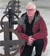  ?? PHOTO: CRAIG BAXTER ?? Another perspectiv­e . . . ‘‘Armistice Day 11.11.18’’ coordinato­r Stuart Griffiths with Sniper’s Prayer, one of sculptor Stephen Mulqueen’s works, at the Athenaeum building in the Octagon.