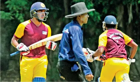  ??  ?? The Masquerade -- Matara District (NCC) batsmen cross over for a run during their match against Hambantota District during their invitation match played in Colombo on Friday - Pic by Amila Gamage