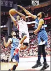  ??  ?? Houston Rockets’ Trevor Ariza (1) shoots as Minnesota Timberwolv­es’ Karl-Anthony Towns (32) defends during the second half of an NBA basketball game, on April 12, in Houston. The Rockets won 123118. (AP)