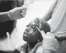  ?? DIEU NALIO CHERY
THE ASSOCIATED PRESS ?? A boy injured by an aftershock receives treatment at the hospital in Port-de-Paix. The aftershock struck on Sunday, even as survivors of the previous day’s quake were sifting through the rubble of their homes.