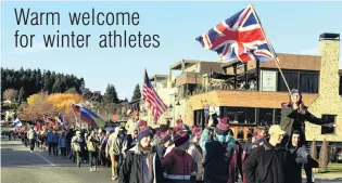  ?? PHOTO: STEPHEN JAQUIERY ?? Top of their class . . . Faith Davis waves her Great Britain flag as she leads the Winter Games parade past the Wanaka township to the opening ceremony.
