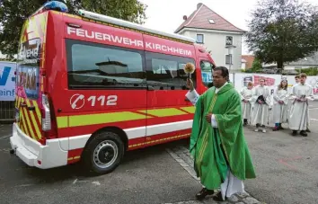 ?? Fotos: Gutmann ?? Mit viel Schwung segnete Pater Benedikt das neue Feuerwehrf­ahrzeug in Kirchheim. Auch die Ehrengäste bekamen dabei vom Weihwasser etwas ab.