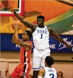  ?? DARRYL OUMI/GETTY IMAGES ?? Duke’s Zion Williamson, here soaring to block the shot of an Auburn player Tuesday, is seen as a potential franchise-changing prospect, one perhaps worth suffering through a painful season to obtain.