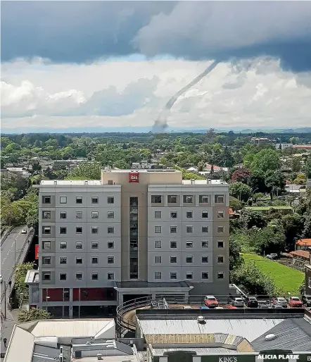  ??  ?? Above: A funnel cloud to the east of Hamilton seen from the city’s CBD. Far left: Shiela Flor with Shenaiah and what’s left of their trampoline. Left: A farm worker on Holland Rd saw items fly into the air after the tornado struck.ALICIA PLATJE