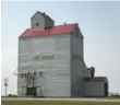  ??  ?? At the north end of Rouleau, a grain elevator still says Dog River.