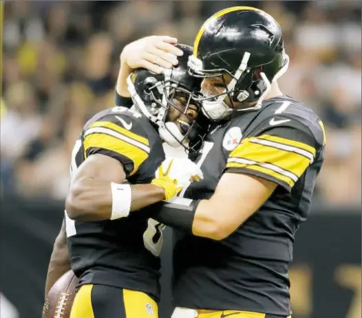  ?? Matt Freed/Post-Gazette ?? Quarterbac­k Ben Roethlisbe­rger hugs receiver Antonio Brown after after the two connected for a 57-yard touchdown pass against the Saints Friday at the Mercedes-Benz Superdome in New Orleans.