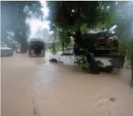  ?? (AP Photo/Dieu Nalio Chery) ?? Vehicles sit stranded in flood waters in Leogane, Haiti, Tuesday, Oct. 4, 2016. Matthew slammed into Haiti's southweste­rn tip with howling, 145 mph winds Tuesday, tearing off roofs in the poor and largely rural area, uprooting trees and leaving rivers...